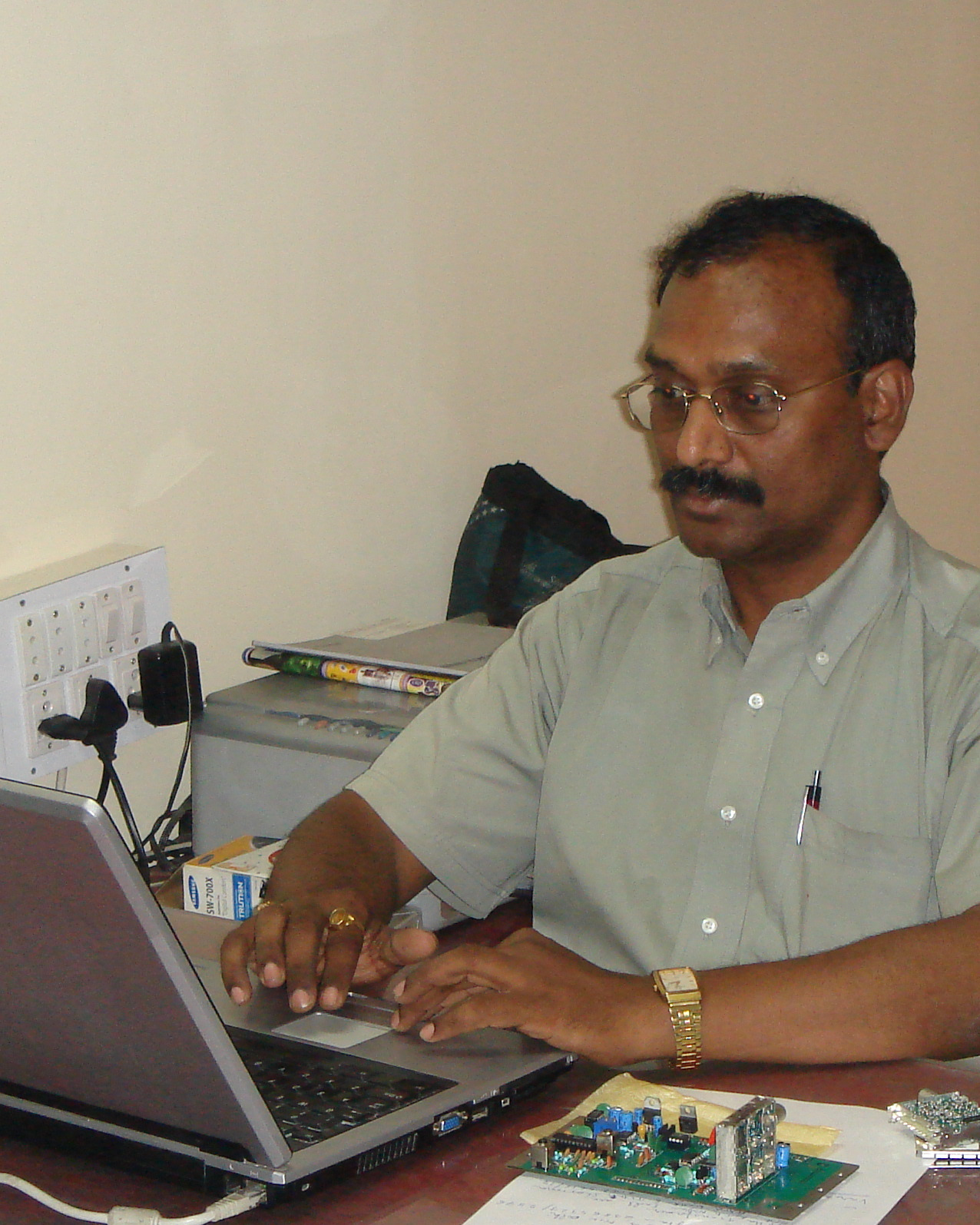 Vijayasree Kumar at his desk reviewing a populated board